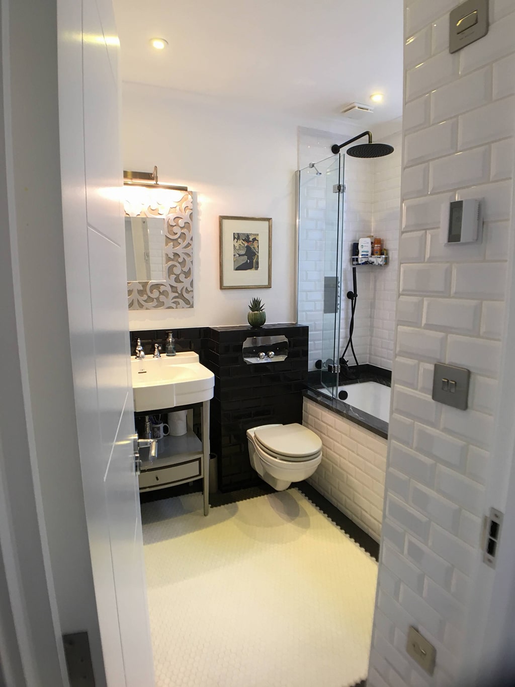 Renovated bathroom with dark wall tiles and traditional-style fittings, Hampstead NW3