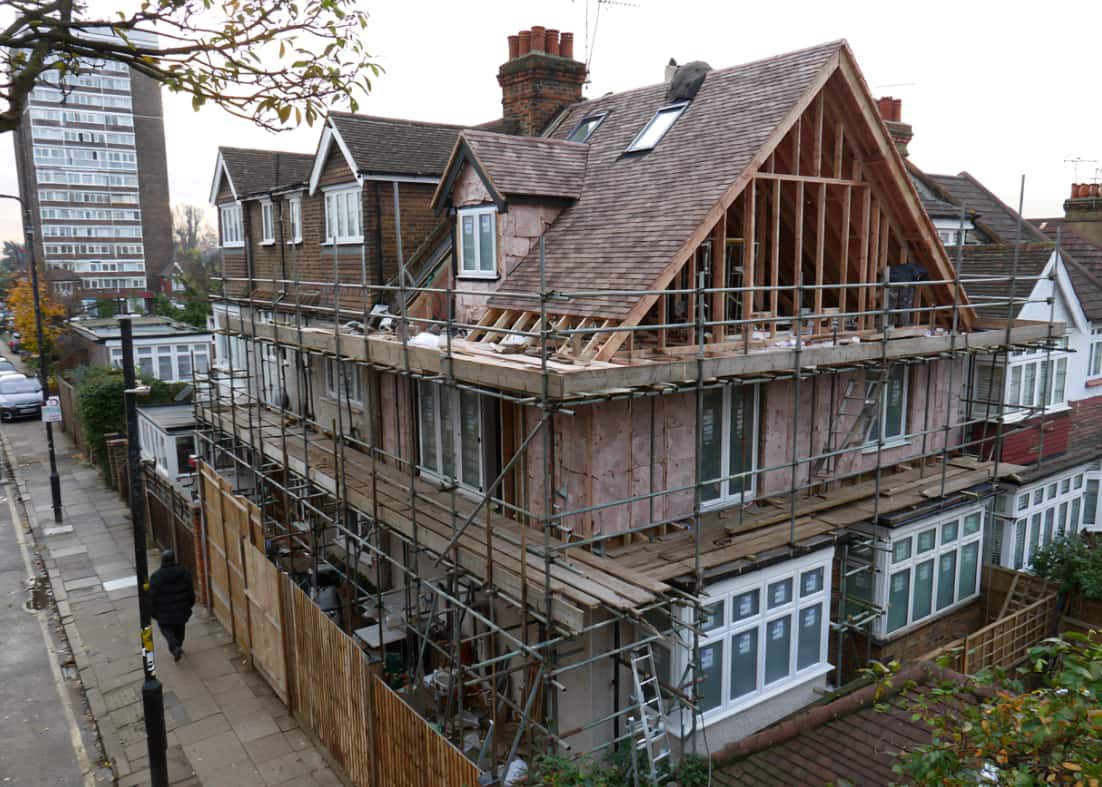 Roof with hip to gable under construction with scaffolding